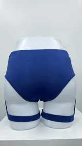 Detailed back view of sexy blue sports shorts with leg straps on a white mannequin display.