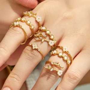 Close-up detail of dainty stainless steel floral rings set featuring sparkling cubic zirconia
