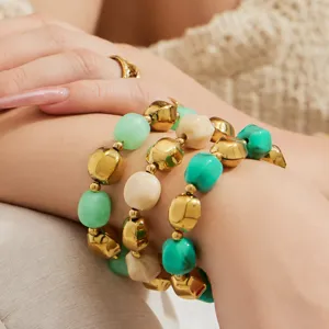 Close-up detail of multi-color beaded bracelet showcasing gold and mint green elements.