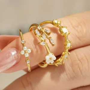 Dainty gold ring set featuring pearl flower, zircon leaves, and opal stones for women.