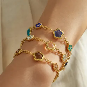 Gold-plated titanium steel bracelet featuring colorful clover flower glass stones detail shot.