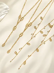 Detailed view of gold stainless steel Y-shaped tassel necklace with anchor links and shell pearls.