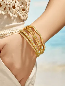 Detailed shot of a stylish multi-layer gold zircon metal cuff bracelet for women.