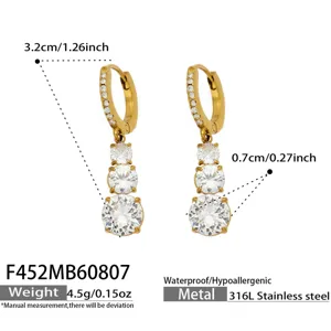 Close-up detail of three-stone zircon drop earrings showing 3.2cm length and stainless steel.
