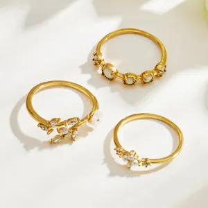 Detailed view of the chic minimalist gold-toned stainless steel zircon and opal ring set.
