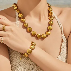 Gold-plated stainless steel round bead necklace and bracelet jewelry set detail view.
