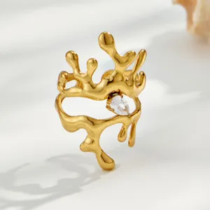 Detail shot of gold-plated stainless steel irregular geometric ring with clear cubic zirconia.