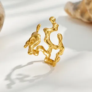 Detail shot of an irregular molten gold ring, minimalist open geometric finger jewelry.