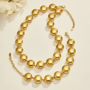 Gold stainless steel spherical bead necklace detail shot, elegant fashion jewelry design.