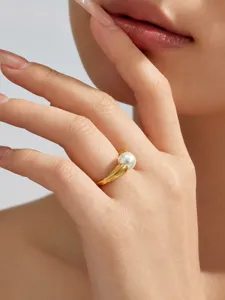 Detailansicht des eleganten unregelmäßigen geschwungenen vergoldeten Perlenrings.