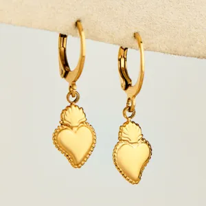 Gold-plated stainless steel sacred heart hoop earrings close-up, elegant fashion jewelry detail.