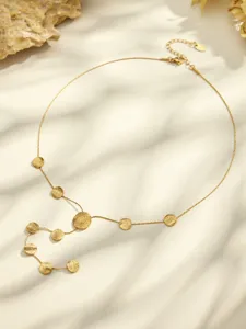 Detail view of gold stainless steel Y-shaped necklace featuring textured disc charms.