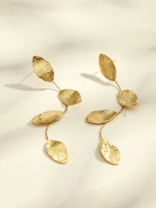 Gold leaf drop earrings detail, elegant textured metal pendant showcasing fine craftsmanship.