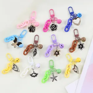 Detailed view of colorful keychain featuring sparkling rhinestone flower and heart pendants with chains.