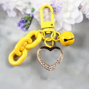 Yellow alloy keychain with chunky chain, cute bell and sparkling rhinestone heart pendant.