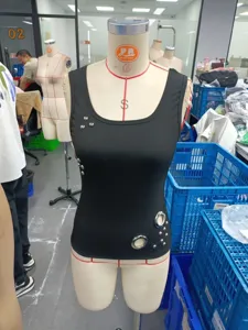 Black slim fit summer tank top with metal eyelets and studs, trendy street fashion style.