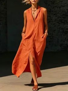 Gedetailleerd close-up van de oranje mouwloze lange jurk met split en zakken.