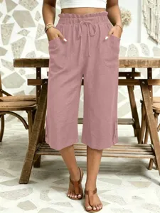 Detail view of casual women's cropped pants featuring elastic drawstring waist and side pockets.
