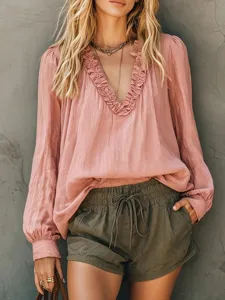 Detailed view of the long sleeve ruffle V-neck blouse featuring chic lantern sleeves design.