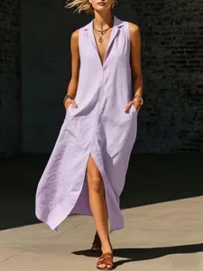 Detail van mouwloze maxi-jurk met reverskraag, split aan de voorkant en handige steekzakken.