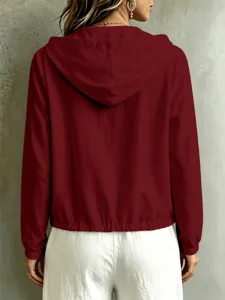 Top casual a maniche lunghe con cappuccio in tinta unita da donna, comodo ed elegante.