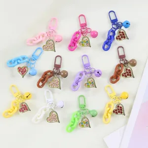 Colorful keychain detail showing chunky plastic chains, cute heart pendants and bells.