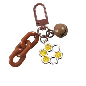 Brown honeycomb keychain detail, glitter honeycomb pendant and cute bell, sweet style.