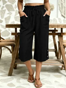 Detail shot of women casual cropped pants, elastic waist, pocket and button decor.