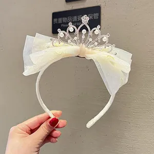 Children crown hair hoop with mesh bow and pearls, sweet kids rhinestone accessory detail.