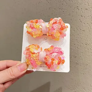 Dettagli di graziosi fermagli per capelli con fiocco di paillettes per bambini colori estivi.