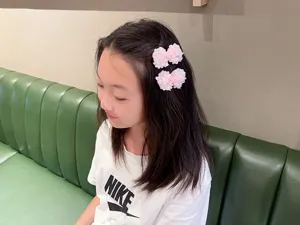 Dettaglio di graziose mollette per capelli a fiocco con paillettes rosa per bambine.