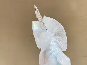 Close-up of blue mesh pearl hair hoop detail, elegant children princess crown accessory.