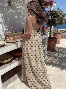 Backless strap long dress scenic detail shot, casual beach holiday style, elegant loose fit.