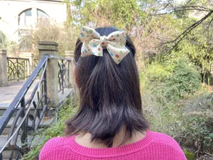 Kids cute cream white polka dot hair bow clip detail view, sweet style hair accessory for girls.