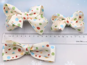 Kids cute cream white polka dot bow hair clip, sweet Korean style children hair accessory detail.