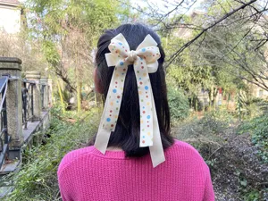 Cream white polka dot hair bow for girls with long ribbons, cute kids hair clip accessory.