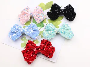 Detail view of colorful velvet sequin bow hair clips set, showing fine texture and vibrant colors.