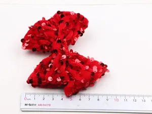 Red velvet sequin bow hair clip detail view, sparkling cute hair accessory for kids.