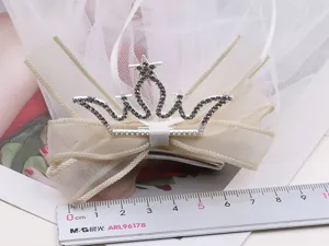 Cute baby girl princess veil hair clip with rhinestone crown and bow for photography.
