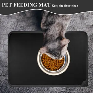 Black silicone pet feeding mat for cats and dogs with anti-spill edge to keep floor clean.