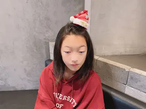 Cute mini Christmas hat hair clip for little girls, festive 3D hair accessory detail view.