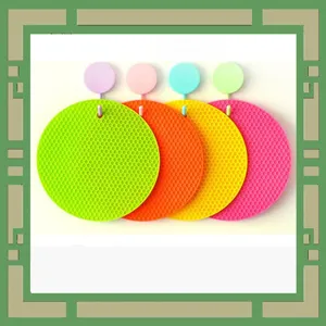 Colorful silicone honeycomb hot pads and coasters with hanging hooks for kitchen heat insulation.