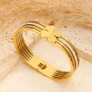 Gold titanium steel clover bangle bracelet with sparkling crystals for women elegant jewelry.