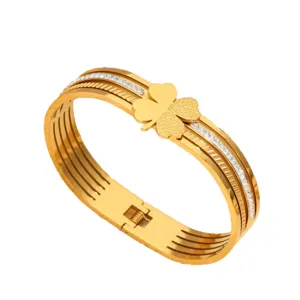 Gold titanium steel clover cuff bracelet with sparkling crystal rhinestones for women.