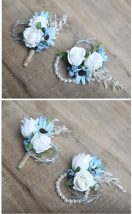 Detailed view of handmade artificial rose boutonniere and pearl wrist corsage set for wedding.