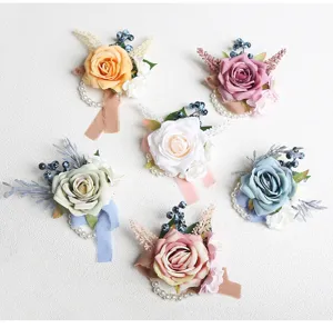 Artificial rose wrist flower details, vintage wedding corsage with pearls and ribbons.