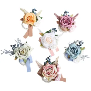 Artificial rose wrist flower wedding corsage set with pearls and ribbons for bridal party decor.
