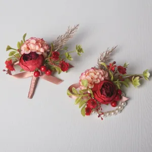 Close-up detail view of the elegant wedding floral boutonniere and pearl wrist corsage.