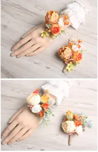 Close up details of orange forest style artificial flower wrist corsage and boutonniere set.
