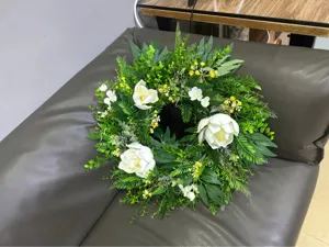 Artificial magnolia green leaf floral wreath for indoor and outdoor front door decor.